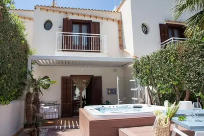 a hot tub in the courtyard of a house at Anemos Apartment - Villa Luna in Macari