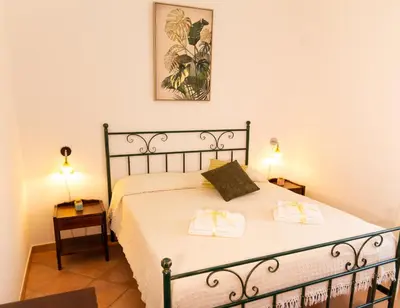a bedroom with a bed with two towels on it at Anemos Apartment - Villa Luna in Macari