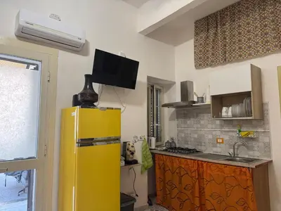 a kitchen with a yellow refrigerator and a sink at Orange Lemon Business Palermo in Palermo