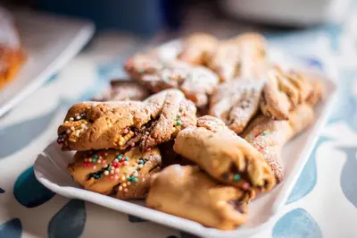 a plate of cookies with sprinkles on a table at La Nicchia in San Vito lo Capo
