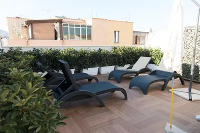 a group of chairs sitting on top of a balcony at La Nicchia in San Vito lo Capo