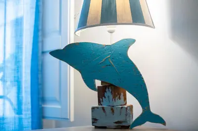 a blue dolphin lamp sitting on top of a table at La Nicchia in San Vito lo Capo
