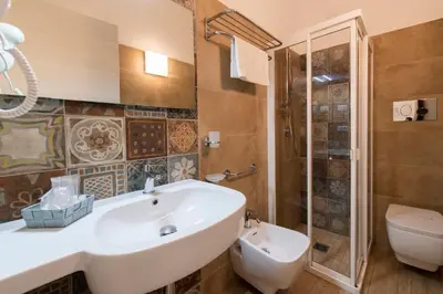a bathroom with a sink and a toilet at La Nicchia in San Vito lo Capo