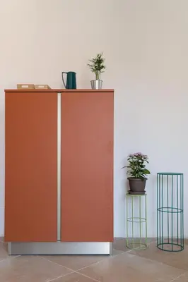 a brown cabinet with plants on it next to a wall at Summaq Terrace in Palermo