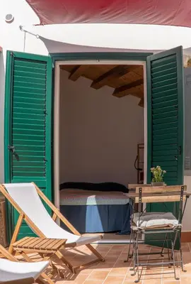 a room with a bed and a table and chairs at Summaq Terrace in Palermo