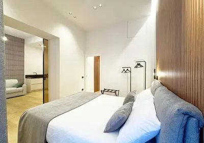 a bedroom with a large white bed with pillows at Solemar Sicilia - Design Apartment Palermo in Palermo