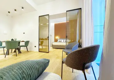a living room with a couch and a bedroom at Solemar Sicilia - Design Apartment Palermo in Palermo