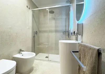 a bathroom with a shower and a toilet and a sink at Solemar Sicilia - Design Apartment Palermo in Palermo