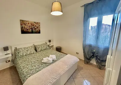 a bedroom with a bed and a window at La Terrazza del Mare in Palermo