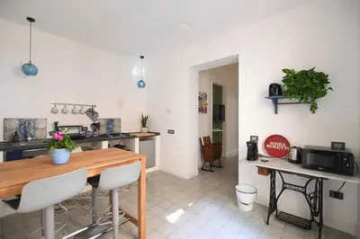a kitchen with a table and chairs in a room at iFlat Un balcone in Cattedrale in Palermo