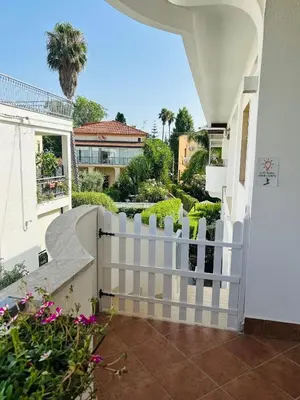 a white fence in front of a house at More Holidays Sun in Mondello
