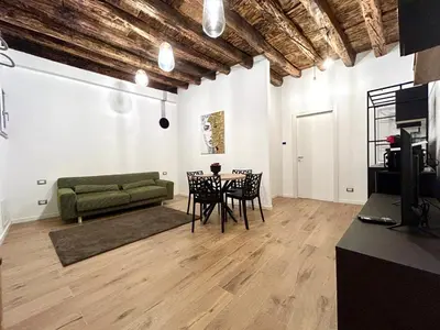 a living room with a green couch and a table at Paternostro Luxury Apartment in Palermo