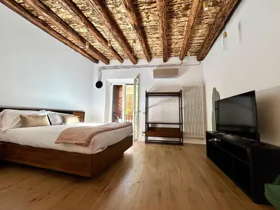 a bedroom with a bed and a flat screen tv at Paternostro Luxury Apartment in Palermo