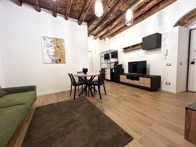a living room with a table and a tv at Paternostro Luxury Apartment in Palermo