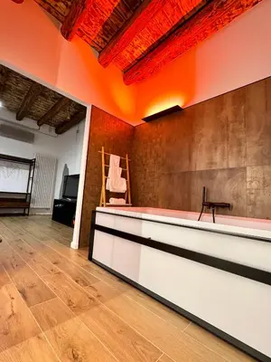 an empty room with a table and a chair at Paternostro Luxury Apartment in Palermo