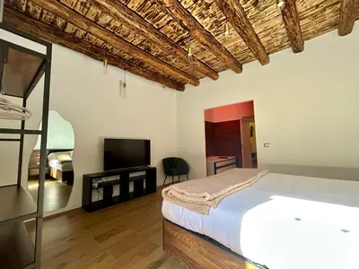 a bedroom with a bed and a flat screen tv at Paternostro Luxury Apartment in Palermo