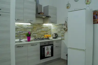 a kitchen with a sink and a stove top oven at Tourist House Palermo in Palermo