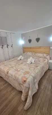 a bedroom with a large bed with a wooden headboard at Tourist House Palermo in Palermo