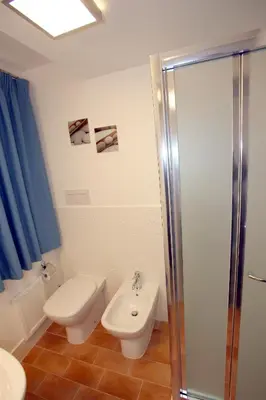 a bathroom with a toilet and a sink and a shower at B&B Teatro in Palermo