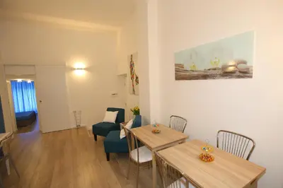 a living room with two tables and a chair at B&B Teatro in Palermo