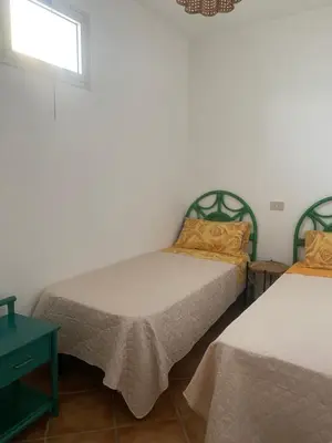 a bedroom with two beds and a window at Baia Marina Suite with private jacuzzi in Balestrate