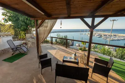 a patio with a view of the ocean at Baia Marina Suite with private jacuzzi in Balestrate