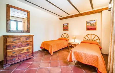 a bedroom with two beds and a dresser at Nice Apartment In Collesano Pa in Lascari