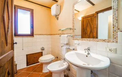 a bathroom with a sink and a toilet and a mirror at Nice Apartment In Collesano Pa in Lascari