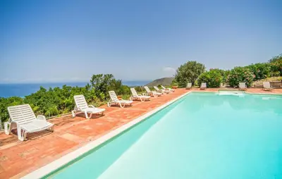 a swimming pool with lounge chairs and a swimming pool at Amazing Apartment In Collesano Pa in Lascari