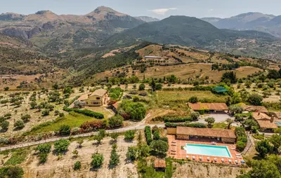 an aerial view of a villa with a swimming pool and mountains at Amazing Apartment In Collesano Pa in Lascari