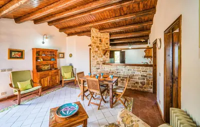 a living room with a table and chairs at Amazing Apartment In Collesano Pa in Lascari