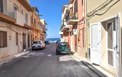 an alley with cars parked on the side of a street at Beautiful Apartment In Trappeto in Trappeto