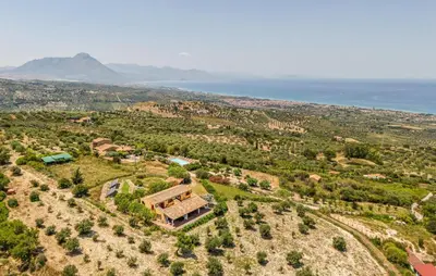 an aerial view of a house on a hill next to the ocean at Stunning Apartment In Collesano Pa in Lascari