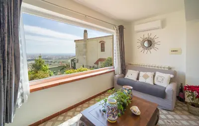 a living room with a couch and a large window at Nice Apartment In Palermo in Palermo