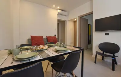 a living room with a table and chairs and a couch at Stunning Apartment In Trappeto in Trappeto