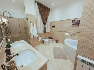a bathroom with two sinks and a tub and a toilet at Sicania - In centro Storico a Palermo in Palermo