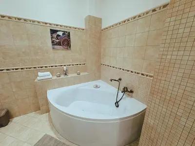 a bathroom with a bath tub in a tiled room at Sicania - In centro Storico a Palermo in Palermo