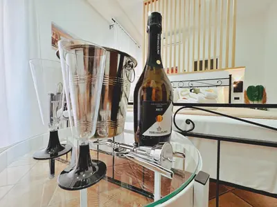 a bottle of wine sitting on a counter next to a blender at Sicania - In centro Storico a Palermo in Palermo