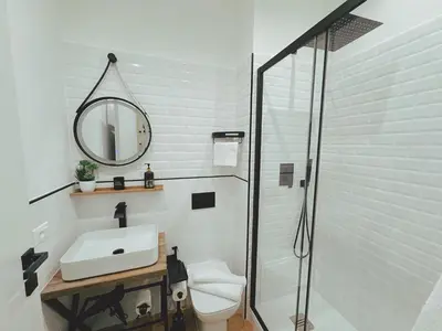 a white bathroom with a sink and a mirror at Sicania - In centro Storico a Palermo in Palermo