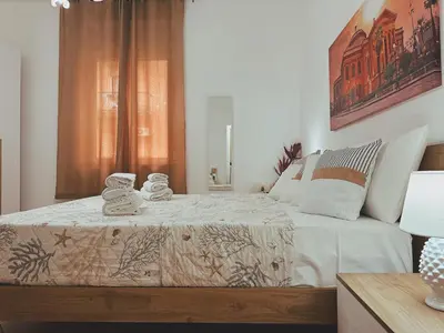 a bedroom with a bed with towels on it at Sicania - In centro Storico a Palermo in Palermo
