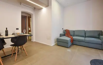 a living room with a blue couch and a table at Stunning Apartment In Trappeto With Wifi in Trappeto