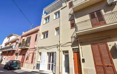 a building with a car parked in front of it at Stunning Apartment In Trappeto With Wifi in Trappeto