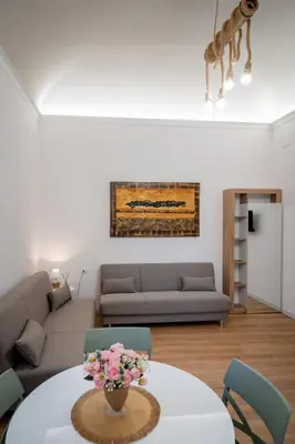 a living room with a couch and a table with flowers at Palermo Centro Gaale in Palermo