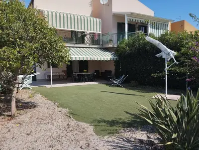 a house with a lawn in front of it at Cento Pini Holiday Cefalù in Buonfornello
