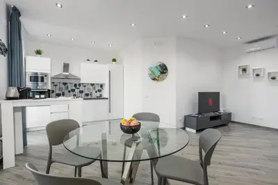 a dining room with a glass table and chairs at Erasmo home luxury, Palermo in Palermo