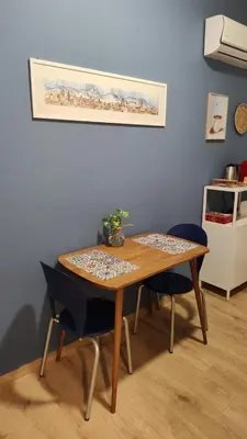 a dining room table with two chairs and a table at Nicasa, accogliente appartamento nel cuore di Palermo in Palermo