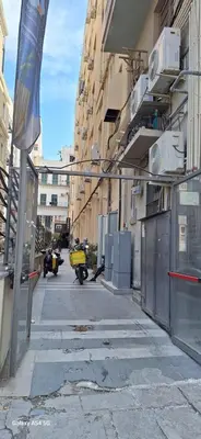 an empty street with a motorcycle parked next to a building at Nicasa, accogliente appartamento nel cuore di Palermo in Palermo