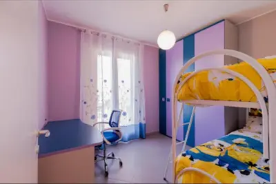 a dorm room with a bunk bed and a desk at Paradiso del mare, Appartamento accogliente vicino a mare, metro, aeroporto e Palermo in Capaci