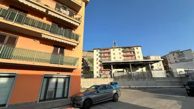 a car parked in a parking lot next to a building at Paradiso del mare, Appartamento accogliente vicino a mare, metro, aeroporto e Palermo in Capaci