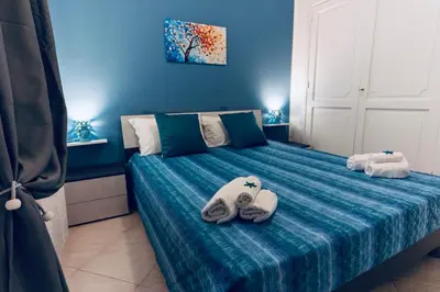 a room with a bed with towels on it at DV holiday home in Isola delle Femmine